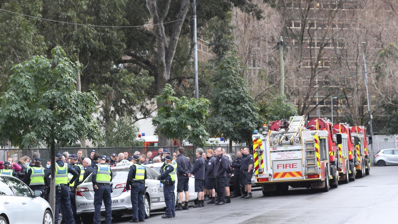 Firefighters and police delivering food to one of the nine towers which went into lockdown before the entire state followed. Picture: David Crosling