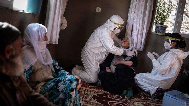 Nurses Gokalp Balli, left, and Bilge Koc from the Gevas Public Health Centre vaccinate Gulendam Ozar, 76, with the Chinese Sinovac Coronavac vaccine in the village of Daldere in Turkey. Picture: Getty Images