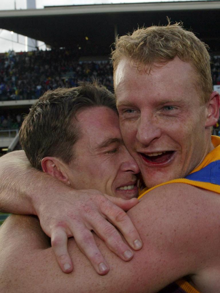 The pair after winning the 2002 grand final with the Lions. Picture: David Kapernick