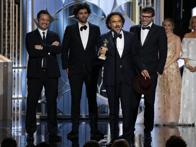 Winners are grinners ... Alejandro Gonzalez Inarritu, accepts the award for best screenplay for Birdman with Alexander Dinelaris, background from left, Armando Bo, and Nicolas Giacobone.