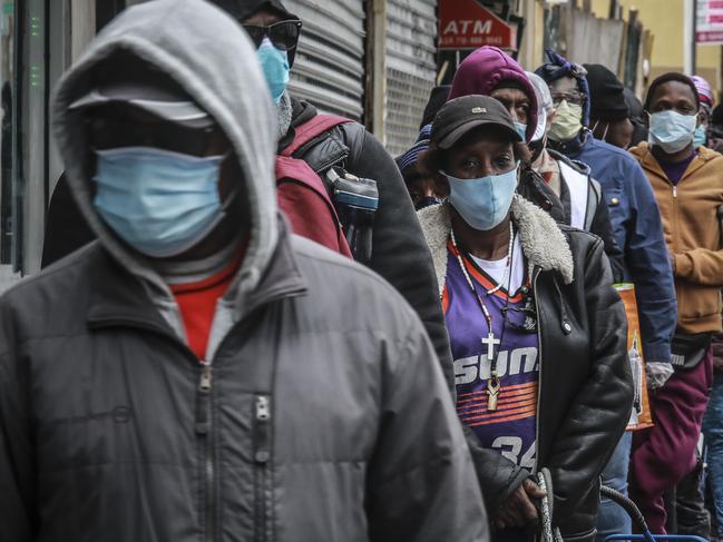 People wait for a distribution of masks and food in New York. Picture: AP