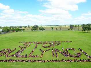 GET THE MESSAGE: North Bundaberg State High School students gather on their school oval to spell out important words ahead of National Day of Action against Bullying and Violence. Picture: Max Fleet BUN190314NSH1