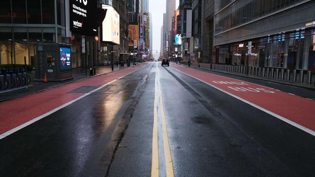 A street stands empty in a mostly desolate Times Square during the coronavirus outbreak in New York City.