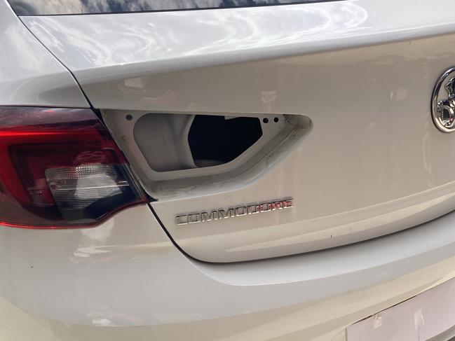 The broken tail light of a Holden Commodore. Two women were arrested after the victim was found with multiple stab wounds in the boot of the car in the NSW Southern Highlands. Picture: Adelaide Lang