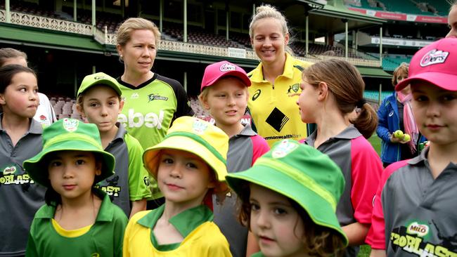 Southern Stars players Meg Lanning and Alex Blackwell with young female cricketers at the Sydney Cricket Ground on Wednesday.