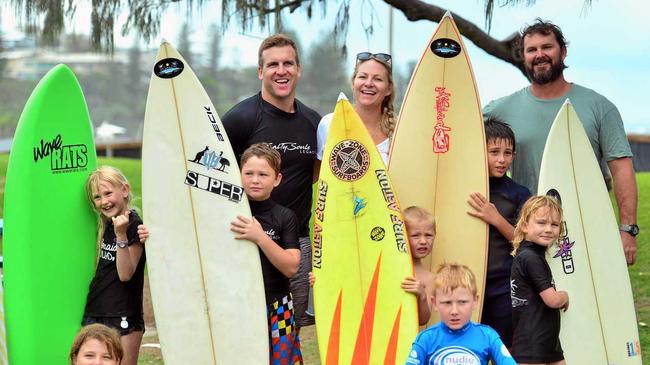 STOKED: (From left) Kerry and Tamara Smith, and Michael Kennedy with some of the children a part of the Salty Souls Legacy program helping vulnerable learn to surf and enjoy the water. Picture: John McCutcheon