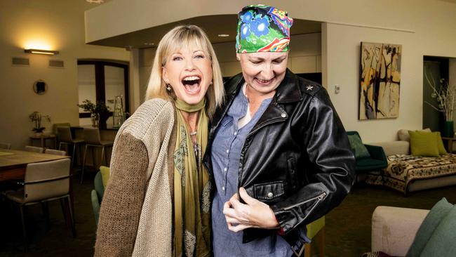 Olivia Newton-John with patient Atalanti Dionysus wearing the Grease jacket that she will auction. Picture: Nicole Cleary