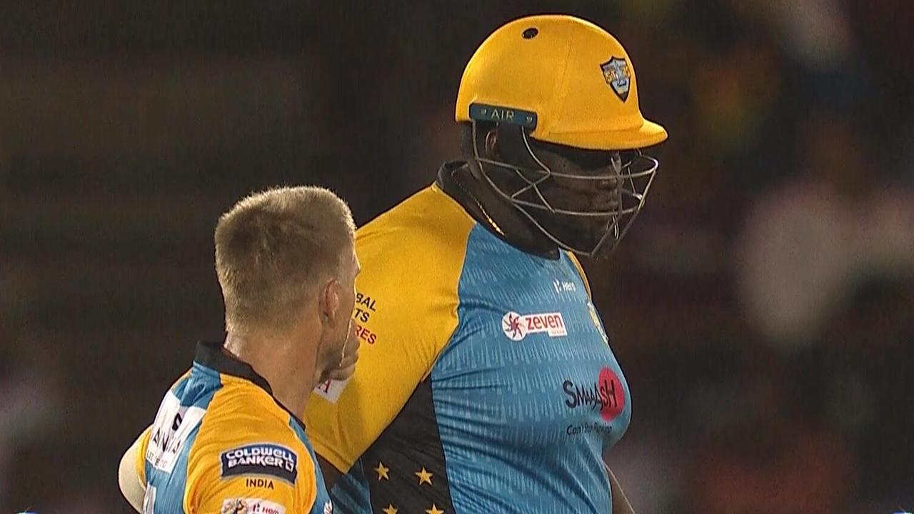 Rahkeem Cornwall playing for St Lucia Stars with David Warner.