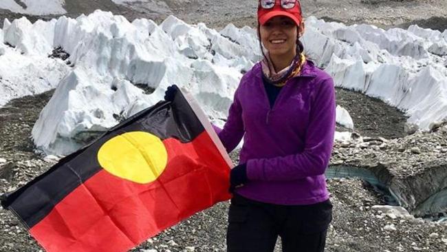 Sarafina Elliott plants the Aboriginal flag on Mt everest Picture: ABC Kimberley