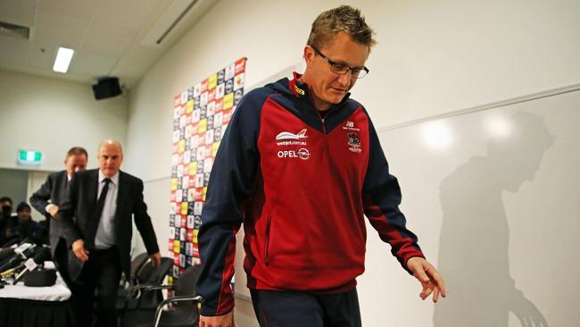 Mark Neeld leaves the Melbourne press conference after losing his job.