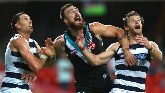 Charlie Dixon battles Geelong’s Harry Taylor and Lachie Henderson. Picture: Getty Images