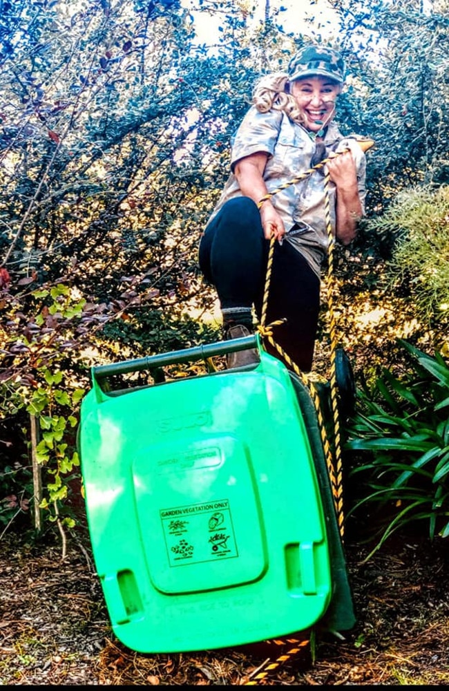 BIN-di Irwin wrestles her bin into submission. Picture: Facebook/Lee Kelly