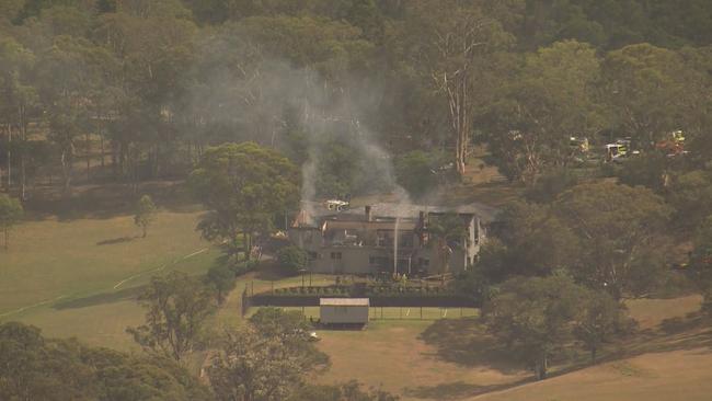 Smoke can be seen coming from the house in Grose Valley as Firefighters put out the blaze . Picture: 9News