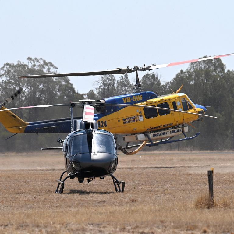 A fire bombing helicopter lands in Tara, Queensland, about 300 kilometres west of Brisbane. Fire fighters have been battling multiple bushfire in Queensland and NSW. Picture: NCA NewsWire / Dan Peled