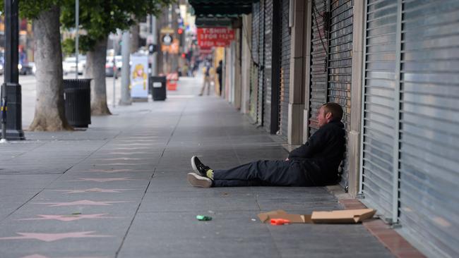 A man sits in front of closed shops along Hollywood Boulevard. Picture: AFP