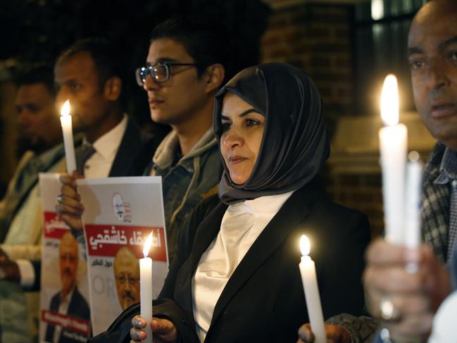 Activists protesting the killing of Saudi journalist Jamal Khashoggi hold a candlelight vigil outside Saudi Arabia's consulate in Istanbul, Thursday, Oct. 25, 2018. A group of Arab and international public, political and media figures are establishing a global association called "Khashoggi's Friends Around the World"; "to achieve justice for the freedom martyr".(AP Photo/Lefteris Pitarakis)