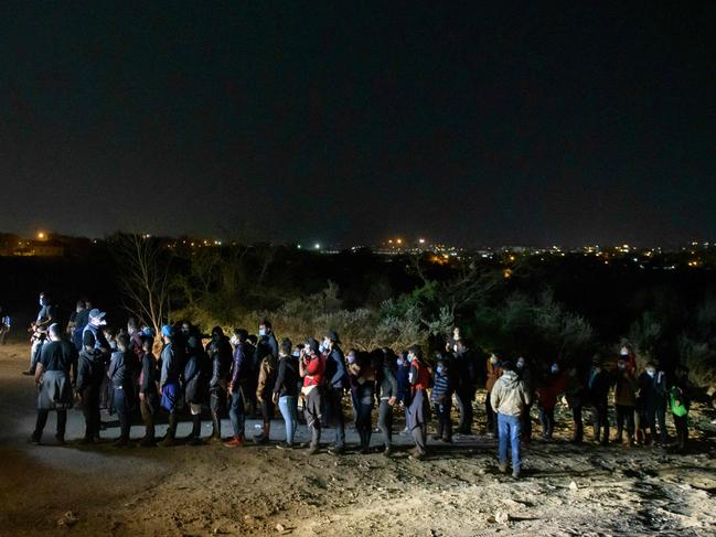 Immigrants who arrived illegally across the Rio Grande river from Mexico at a processing checkpoint before being detained by border patrol agents in the border city of Roma. Picture: AFP