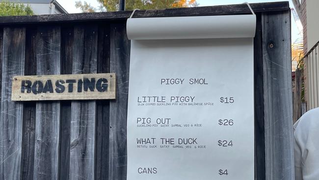 The backyard fence featuring the menu at Piggy Smol. When the gate is closed the only hint of what’s inside is the succulent smells ... and the queue. Picture: Supplied