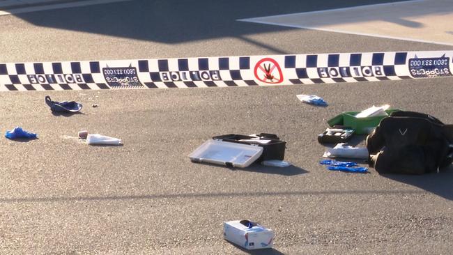 A black bag and first aid kit are among items left scattered on the ground. Picture: TNV