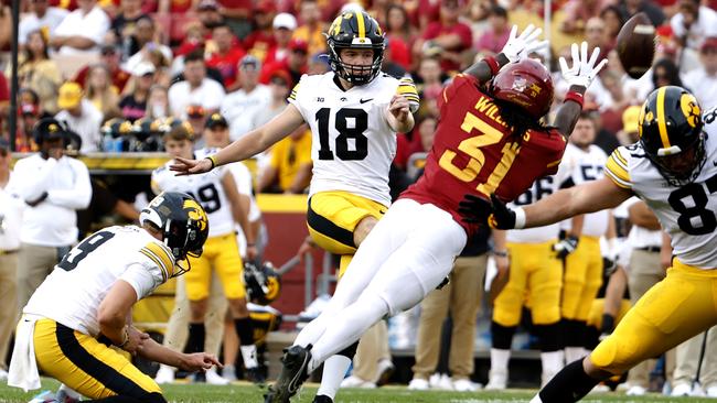 Tory Taylor was also the holder for place kicker Drew Stevens, pictured here kicking a field goal as defensive back Jontez Williams blocks in the second half of play. The Hawkeyes won 20-13 over Iowa State. (Photo by David Purdy/Getty Images)