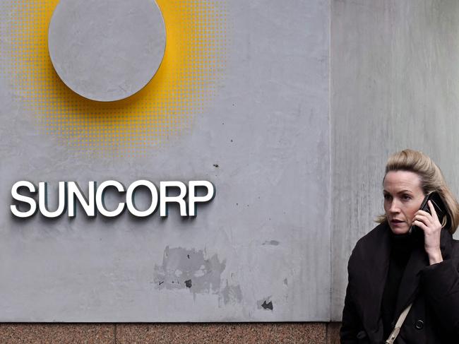 A pedestrian walks past a Suncorp Bank branch in Melbourne on July 18, 2022. - Australian banking giant ANZ announced on July 18 a 3.3 billion USD deal to swallow regional lender Suncorp Bank -- one of the biggest takeovers in the sector for more than a decade. (Photo by William WEST / AFP)