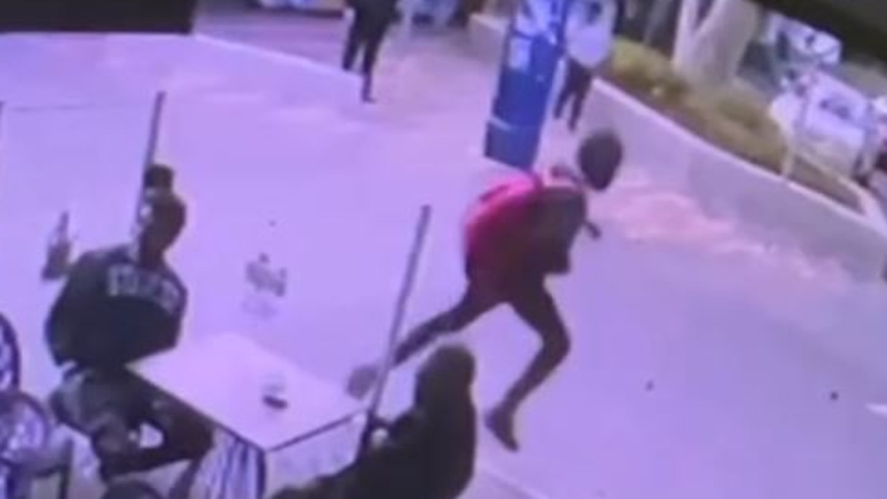 Footage from the Gojo Ethiopian Cafe shows two people running, one with a knife and a red backpack, along Clarke St past a group of diners. Picture: Supplied