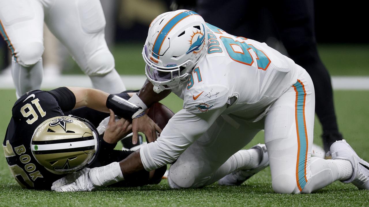 NEW ORLEANS, LOUISIANA - DECEMBER 27: Emmanuel Ogbah #91 of the Miami Dolphins sacks Ian Book #16 of the New Orleans Saints in the fourth quarter of the game at Caesars Superdome on December 27, 2021 in New Orleans, Louisiana. (Photo by Chris Graythen/Getty Images)