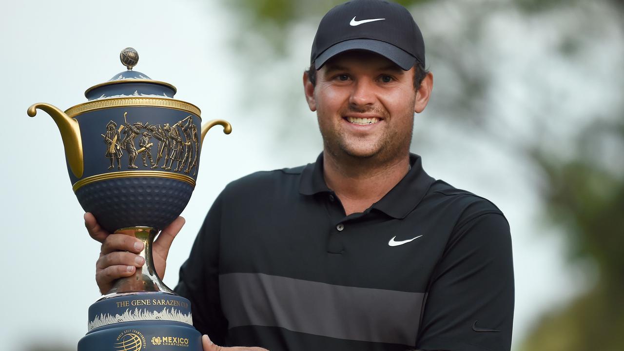 US golfer Patrick Reed holds the trophy after winning the World Golf Championship, at Chapultepec's Golf Club in Mexico City.