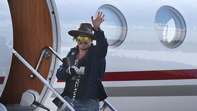 Johnny Depp boards a plane at the Brisbane Airport to fly back to the US for treatment on his hand. Picture: Annette Dew