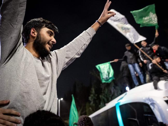 A Palestinian prisoner (wearing grey jumper) cheers among supporters and relatives after being released from Israeli jails in exchange for Israeli hostages. Picture: AFP