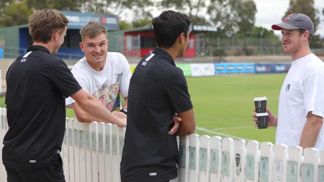 Jackson Mead and Trent Burgoyne chat to Power co-captains Ollie Wines and Tom Jonas after their press conference at Alberton Oval. Picture: Russell Millard/AAP