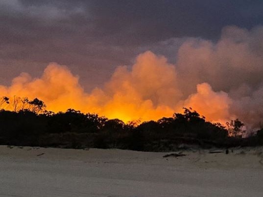 Fires on Moreton Island near the township of Cowan Cowan on Saturday. Picture: Angela Topatig