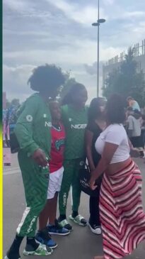 Nigerian basketball players pose with fans