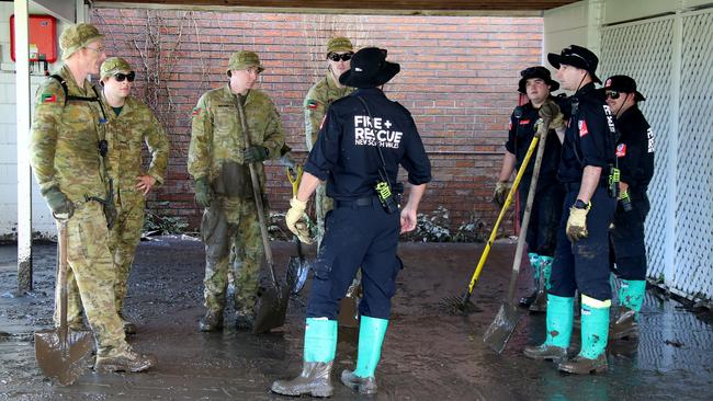 Members of the ADF join Fire &amp; Rescue NSW personnel in Port Macquarie to help with the flood clean up. Picture: Nathan Edwards