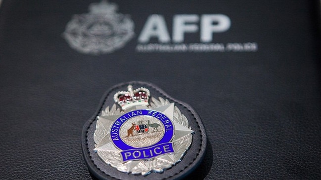 A Logan teen was arrested for allegedly possessing child abuse material, from an international tip-off. Generic image of Australian Federal Police badge