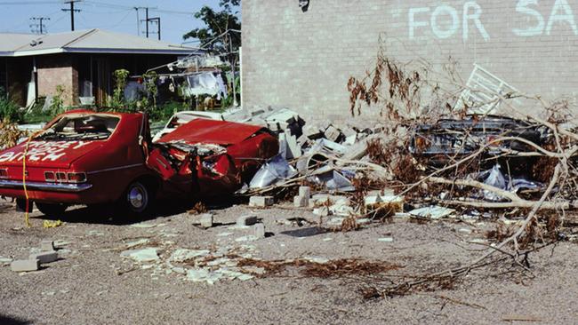 John Garner's crushed Holden Torana, emblazoned with the phrase 'Tracey [sic] You Bitch' became one of the defining images of Cyclone Tracy and its aftermath. Picture: Supplied