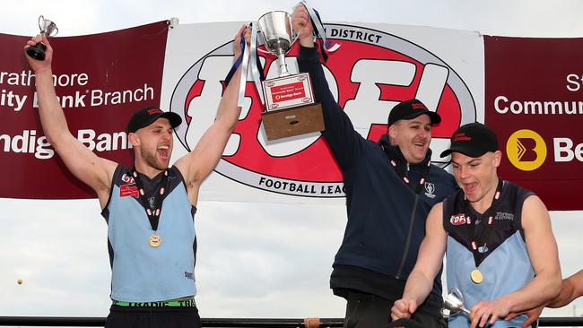 Aberfeldie captain Luke Davis and coach Adam Potter lift the premiership cup.