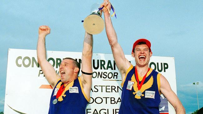 Skipper Todd Power (right) lifts the premiership cup after Vermont won the 2001 grand final.