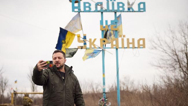 Ukrainian President Volodymyr Zelensky recording a video address in front of a sign reading “Avdiivka is Ukraine” in the town of Avdiivka, Donetsk.