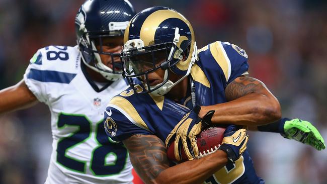 Chris Givens of the St. Louis Rams makes a catch against Marcus Burley.