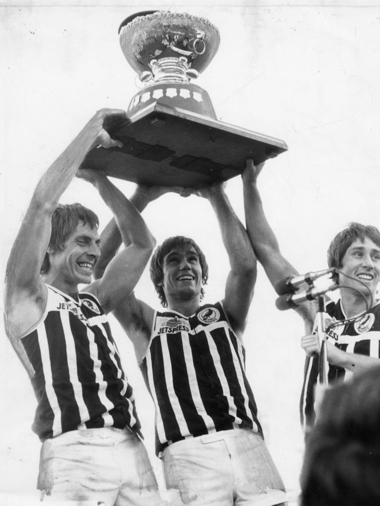 Russell Ebert, Greg Phillips and Brian Cunningham hold aloft the Thomas Seymour Hill trophy in 1980.