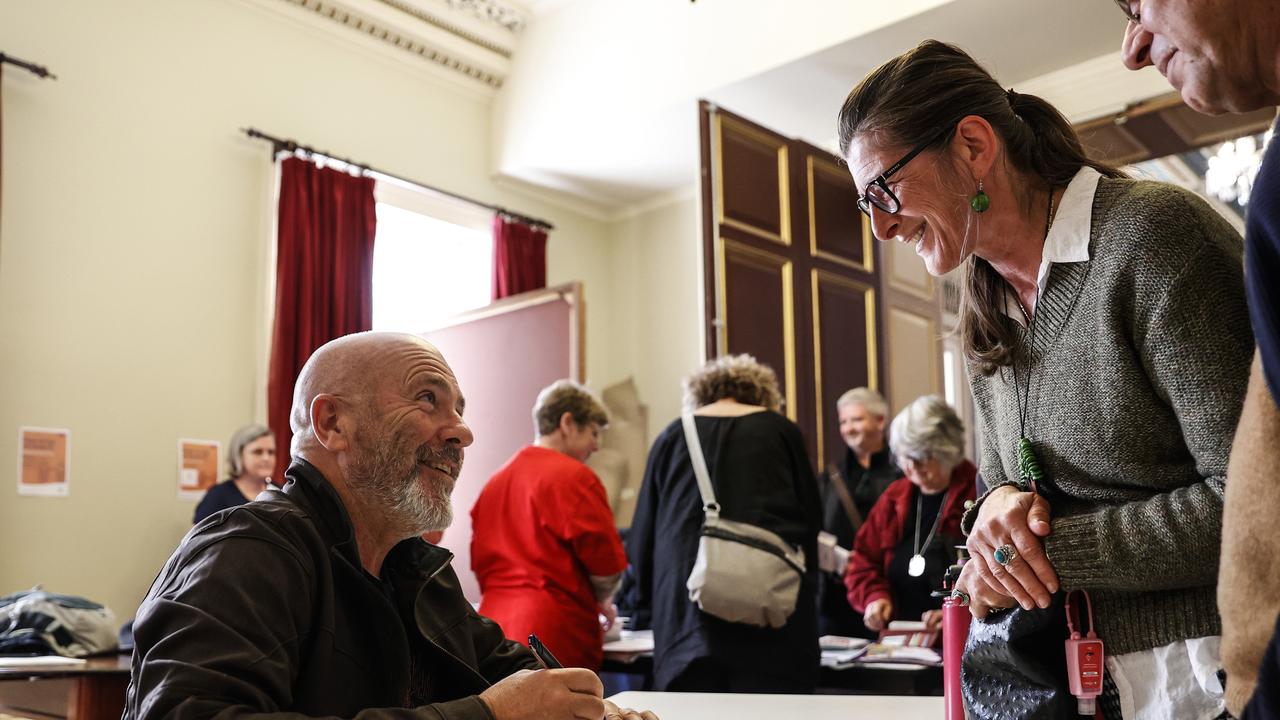 Richard Flanagan signs his book Toxic for fan Hrisanthi Dokos of Dodges Ferry after he spoke at the Stop the Salmon Sea Grab public meeting at Town Hall. Picture: Zak Simmonds