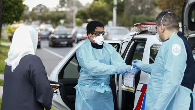 Paramedics perform COVID-19 tests in Broadmeadows. Picture: AAP