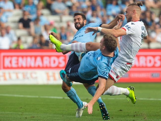 Ken Ilso Larsen of Adelaide has his shot blocked by Michael Zullo and Aaron Calver of Sydney FC during this header in the Round 13 A-League match between the Sydney FC and the Adelaide United at Jubilee Stadium in Sydney, Sunday, January 13, 2019. (AAP Image/Steve Christo) NO ARCHIVING, EDITORIAL USE ONLY