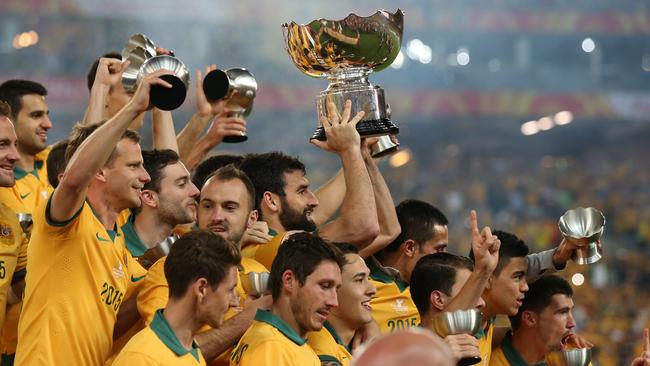 Australian players celebrate with their trophies.