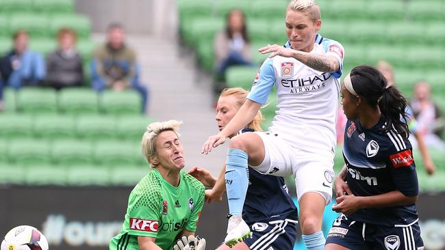 W-League derby Melbourne City v Melbourne Victory City forward Jessica Fishlock splits victory defenders Samantha Johnson & Alexandra Cheal & Victory goal keeper Bianca Henniger to score the first gosl Picture:Wayne Ludbey