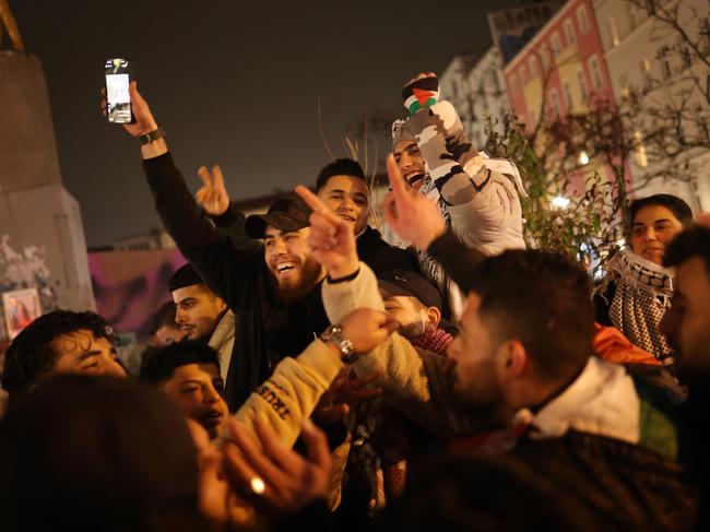 Young Arab men celebrate the announcement of the Gaza ceasefire in Berlin, Germany. Picture: Getty Images