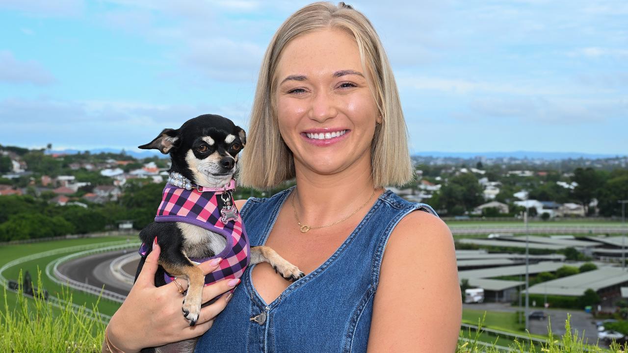 Leah Kilner with her dog Chanel, on top of her Brisbane apartment building which overlooks Eagle Farm racecourse. Picture: Grant Peters / Trackside Photography