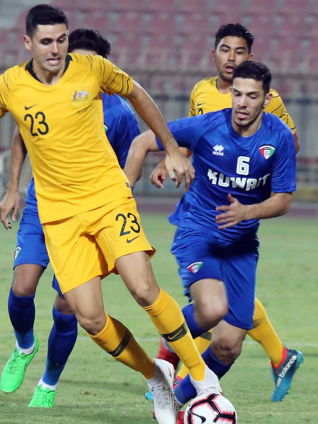 Australia's Tom Rogic takes on the Kuwait defence. Photo: AFP