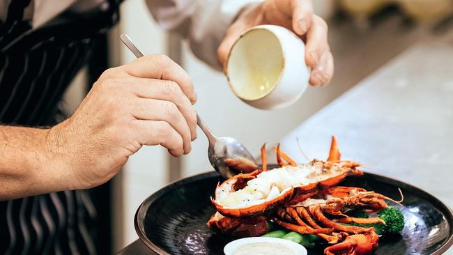 Tony Howell prepares a lobster dish at Cape Lodge.